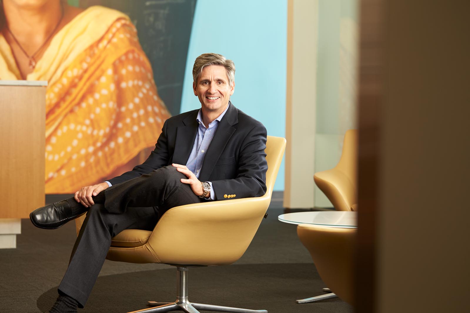Portrait of man in chair before retouching
