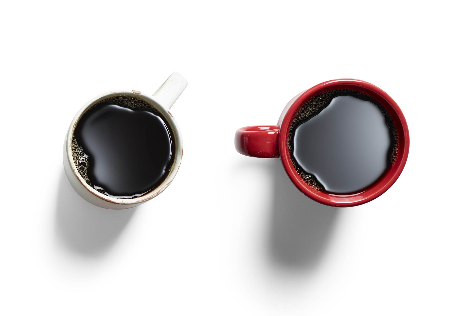 Drink photography - two coffee cups with black coffee on a white background